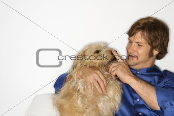 Man with fluffy brown dog.