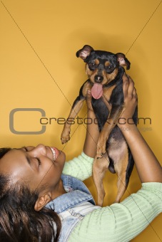 Woman holding small dog.