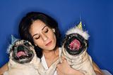 Woman holding two Pug dogs.