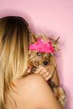 Woman holding Yorkshire Terrier dog.