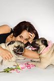 Woman with two Pug dogs.