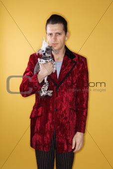 Man holding Chinese Crested dog.