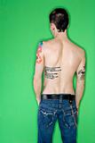 Man's back with tattoos.