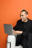 Businessman with mohawk on laptop.