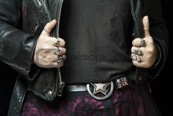 Caucasian woman's hands on leather jacket.