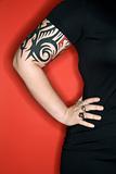 Caucasian woman's tattooed arm.