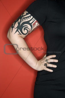 Caucasian woman's tattooed arm.