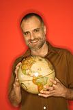 Caucasian man holding globe.