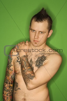 Shirtless Caucasian man with tattoos.
