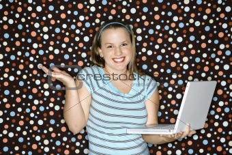 Young Caucasian woman holding laptop shrugging.