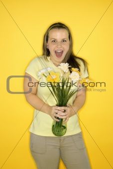 Young Caucasian woman holding flowers.