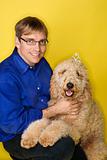 Caucasian man with Goldendoodle dog.