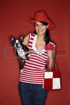 Young Caucasian woman holding Boston Terrier dog.