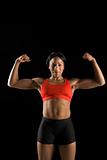 Woman athlete flexing muscles.