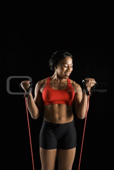 Woman stretching resistance tube.