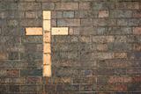 cross of christ built into a brick wall