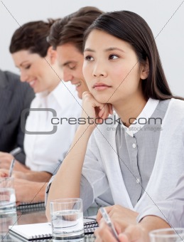 Asian businesswoman bored at a presentation 