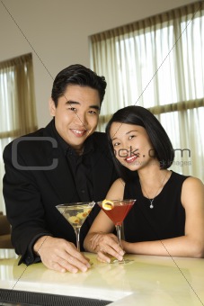 Attractive Young Couple With Cocktails Smiling