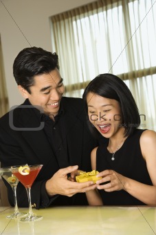 Attractive Young Man Giving Gift to Woman
