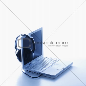 Headphones Hanging on Screen of Laptop. Isolated.