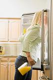 Young Woman Looking in Refrigerator