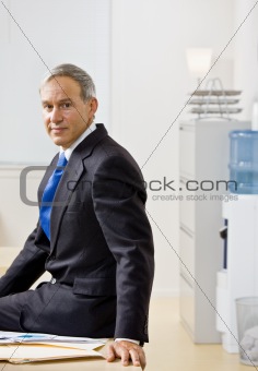 Businessman sitting on desk