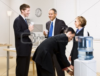 Business people drinking water at water cooler