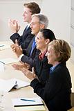 Business people clapping in meeting