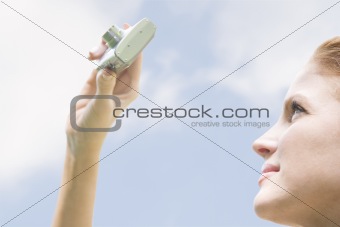 Young Woman Outdoors with Camera