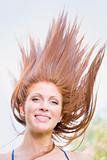 Young Woman Outdoors With Windblown Hair