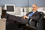 Businessman with feet up at desk