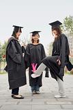 Three Female Graduates Playing Game