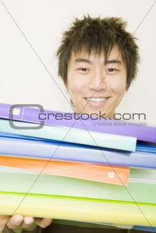 Young Man Holding Colorful Notebooks