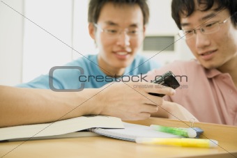 Young Men Looking at Cell Phone
