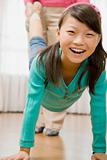 Girl Walking on Hands as Woman Holds Her Legs