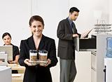 Businesswoman carrying tray of coffee