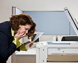Businesswoman having trouble with copy machine