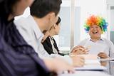 Businessman Wearing Clown Wig During Meeting