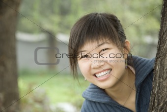Smiling Woman By Tree