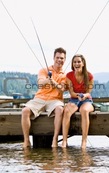 Couple fishing on pier