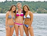 Friends in bikinis near lake