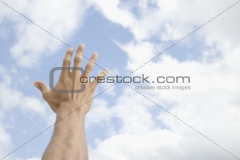 Male Hand Extended Toward Sky