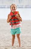 Girl wearing life jacket at beach