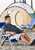 Man using mp3 player at campsite