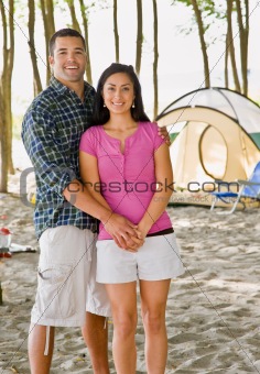 Couple holding hands at campsite