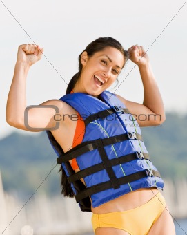 Woman wearing life jacket at beach