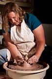 Woman working with clay in studio