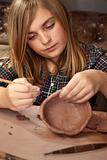 Young girl in clay studio