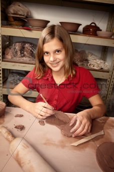 Young girl working in clay studio