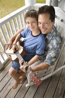 Father and Son on Porch Playing Guitar